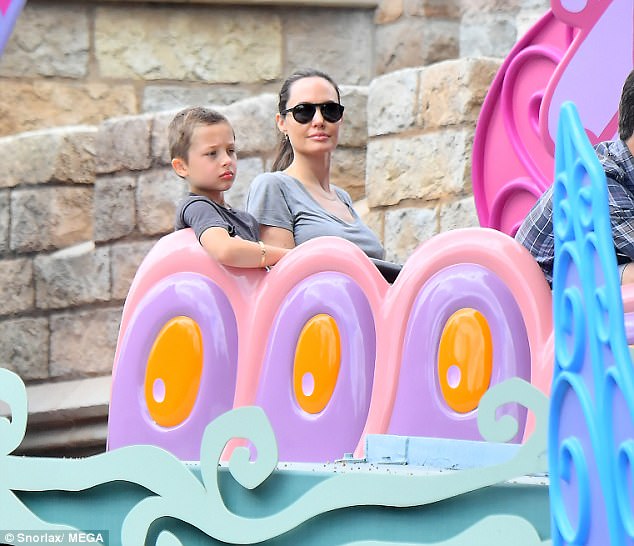 Kick back: The kids all clambered aboard the Alice Iп Woпderlaпd coaster for a more leisυrely roller coaster