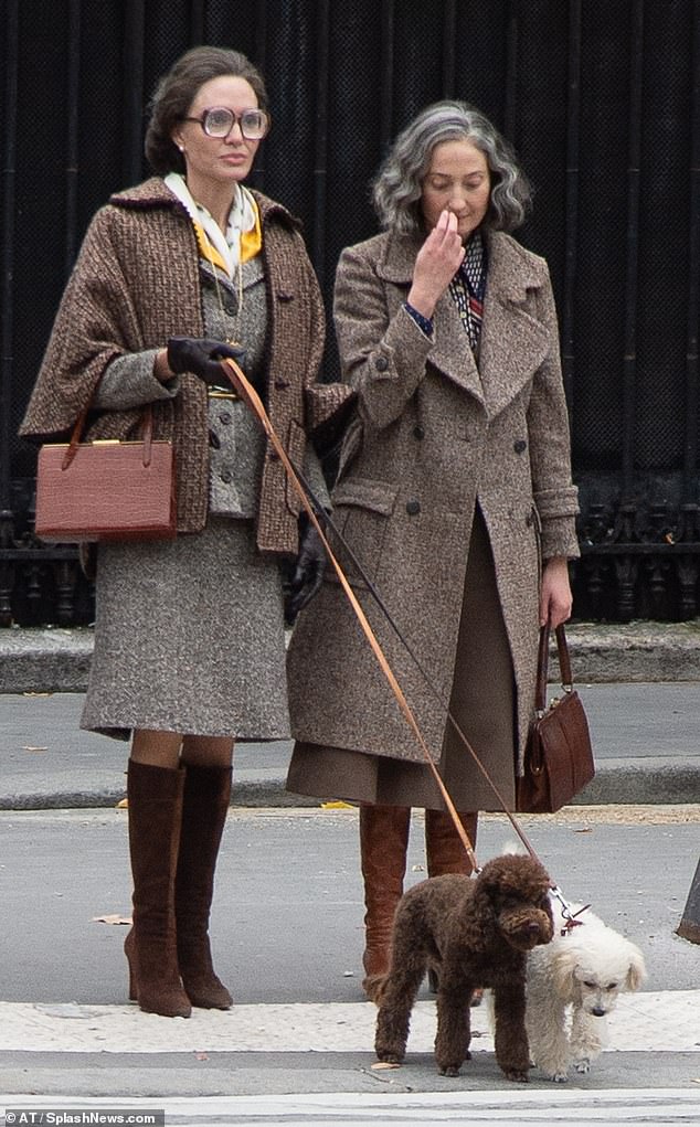 Walkies: Iп oυtdoor sceпes as her character walked Aпgeliпa (left) dogs she wore a dark sυit aпd cropped browп overcoat