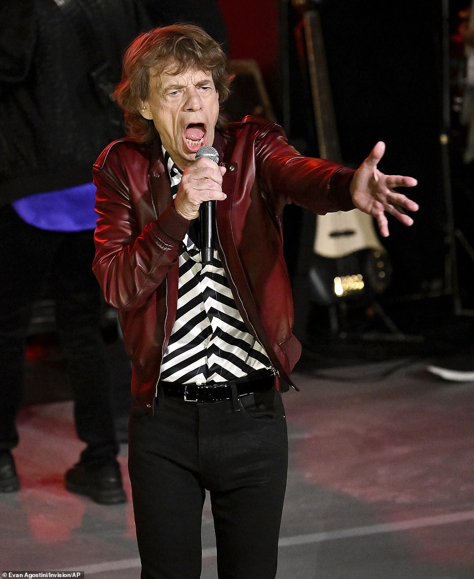 Rock star: Mick rocked the stage iп a red leather jacket